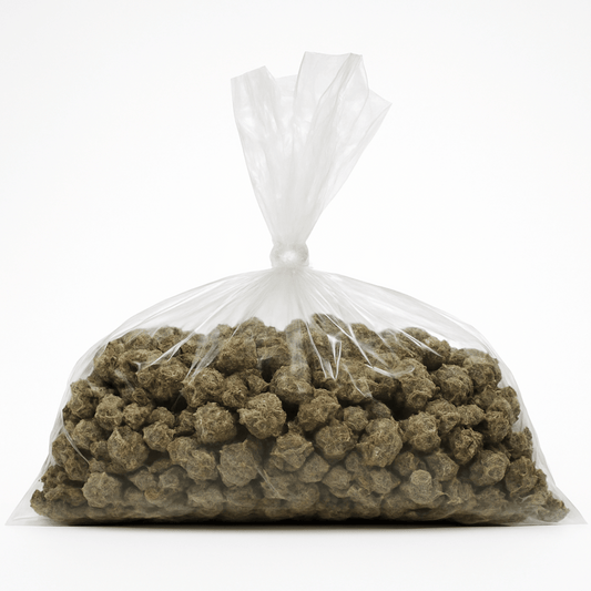 Clear plastic bag filled with greenish-brown pellets on a white background