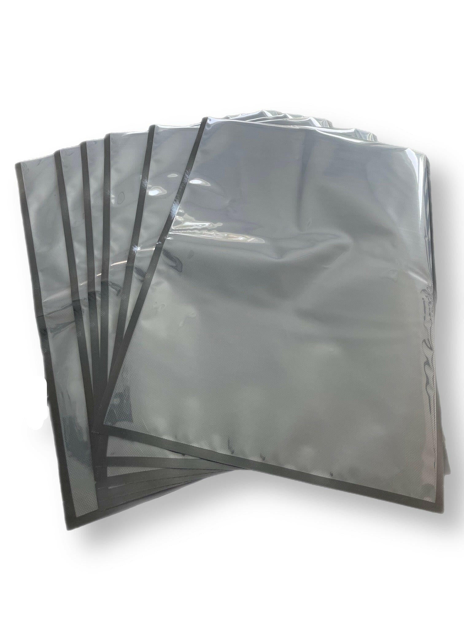 Stack of 11x24 inch 454 Bags with dual-tone black and clear design for storage.