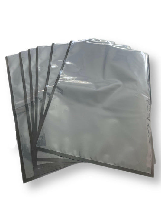 Stack of 11x24 inch 454 Bags with dual-tone black and clear design for storage.