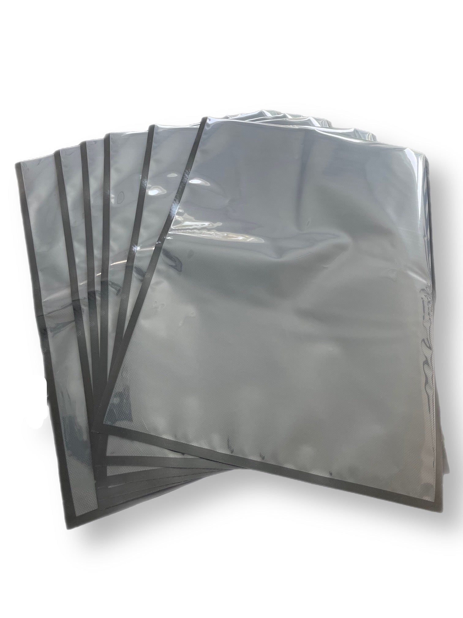Stacked 454 Vacuum Bags sized at 11"x24", highlighting their precision cut and dual-tone design with one side black and the other clear